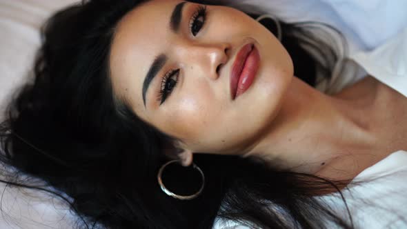 Portrait of Beautiful Sexy Young Asian Woman Lying in Bed alt