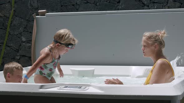 Mom with Kids Enjoying the Time in Outdoor Jacuzzi Tub