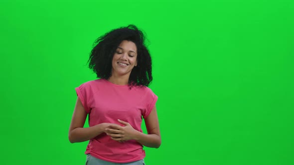 Portrait of Young Female African American Waving Hello and Communicating with Someone in a Friendly alt