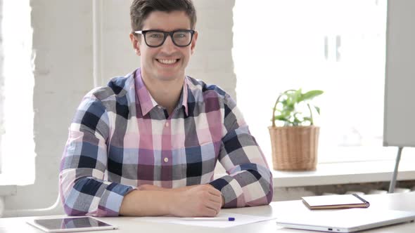 Smiling Young Man in Office Looking at Camera alt