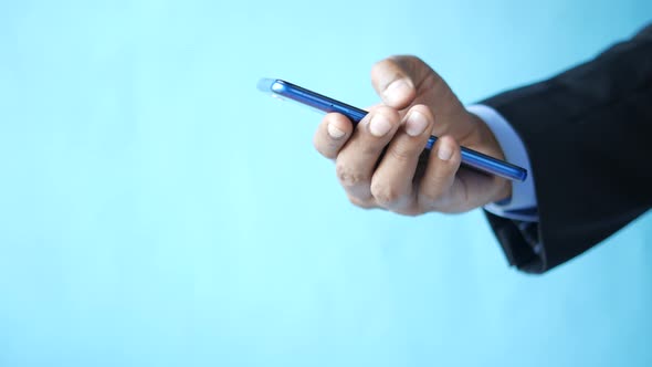 Close Up of Young Man Hand Using Smart Phone alt