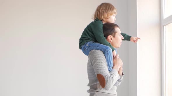 Father and Son Stand By Window Spend Time Together Love Each Other alt