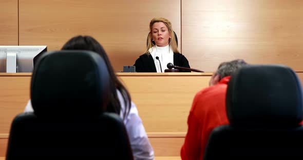 After the trial judge banging gavel on sounding block alt