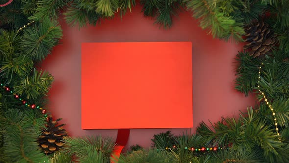 Red Ribbon Wrapping Around Box With Striped Candy Canes and Tying in Bow, X-Mas alt