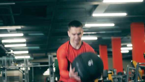 A Man Gets Tired During Crossfit Workout with a Ball alt
