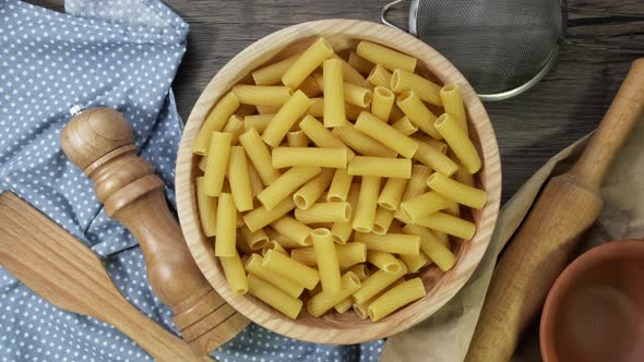 Fusilli Pasta Dry on the Table Slowly Rotates. On Wooden Plait Top View. alt
