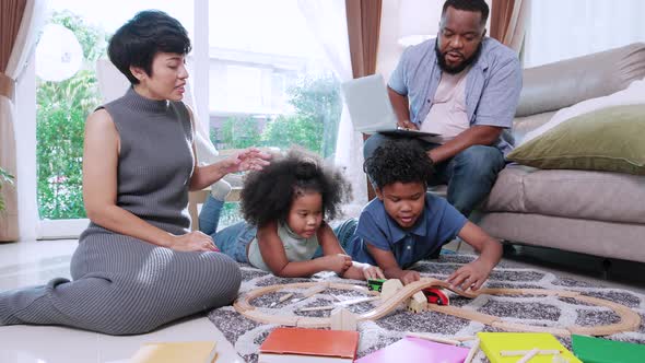 African American family in living room activity concept. children relax and develop with education