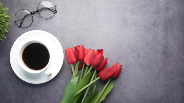 Flat Composition Coffee Tulip Flower and Eyeglass on Black Background alt