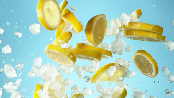 Super Slow Motion Shot of Flying Fresh Lemon Slices and Crushed Ice on Blue Background at 1000 Fps alt
