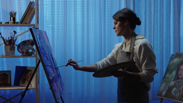 Talented Artist Works on Oil Painting Using a Brush She Draws Modern City with Houses alt