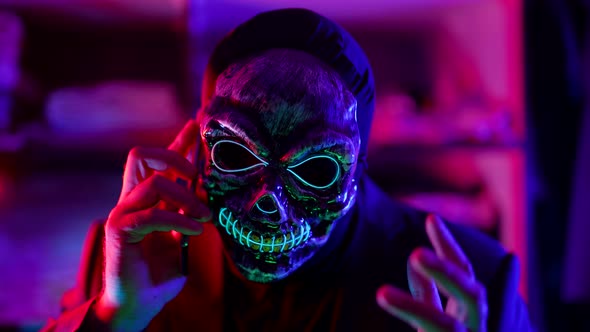 Phone Scammer Calling By Cell Phone Person with Gloomy Skull Mask with Mobile alt