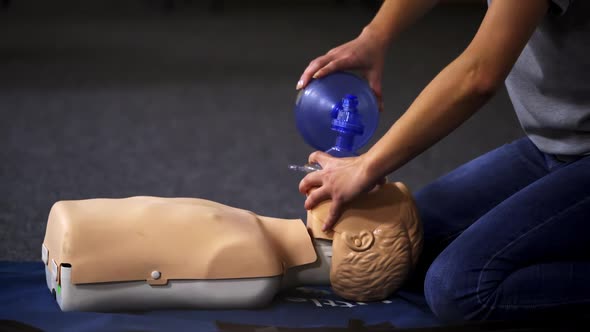 Resuscitation during first aid training. First aid instructor showing resuscitation technique on dum alt