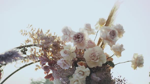 Close Up View of Wedding Floral Decorations Arch of Flowers in Pastel Faded Colors Slow Motion alt