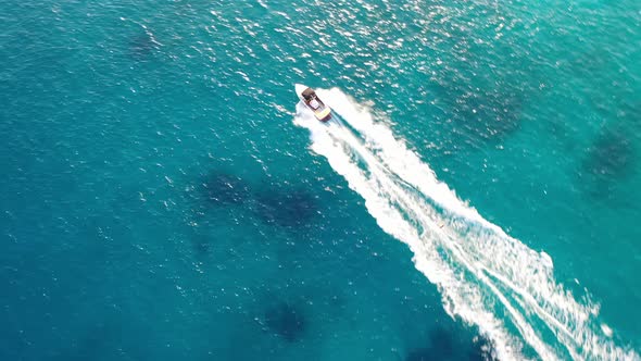 Aerial View of a Motor Boat Towing a Water Skier. Elounda, Crete, Greece