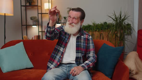 Senior Man Real Estate Agent Showing the Keys of New Home House Apartment Buying or Renting Property alt