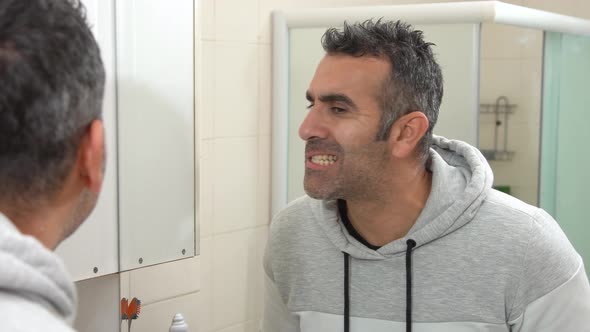 Dirty teeth and unhappy man. alt