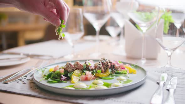 A dish of tuna and salad, decorated with potion. In the restaurant alt