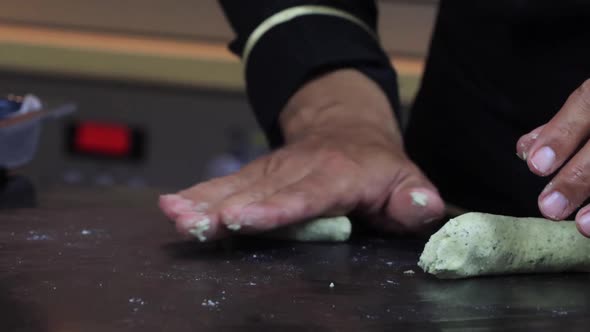 An Experienced Chef in a Professional Kitchen Prepares the Dough  with Flour alt