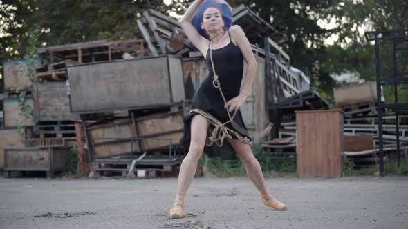Young Caucasian Woman in Pointes Bound with Rope Dancing on Urban Slum alt