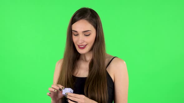 Girl Opens a Small Box with Surprise and Is Very Disappointed with What She Saw alt