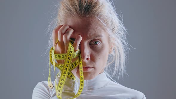 Anorexic Model Holding Measuring Tape
