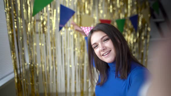 A Young Cheerful Girl Celebrates Her Birthday at Home with Decorations Alone Communicates on a alt