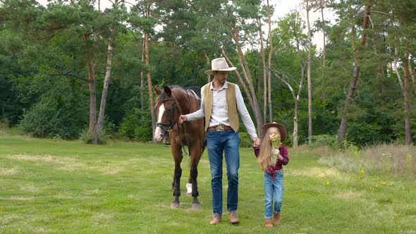 Cowboy with His Daughter Walking with a Horse on a Forest Road alt