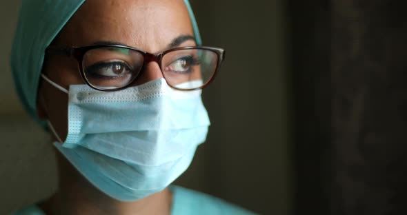 Young female medic, wearing a mask and glasses