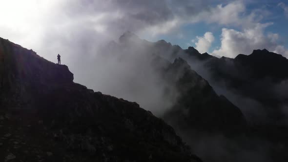 Man On The Mountain Tops Taking Pictures alt