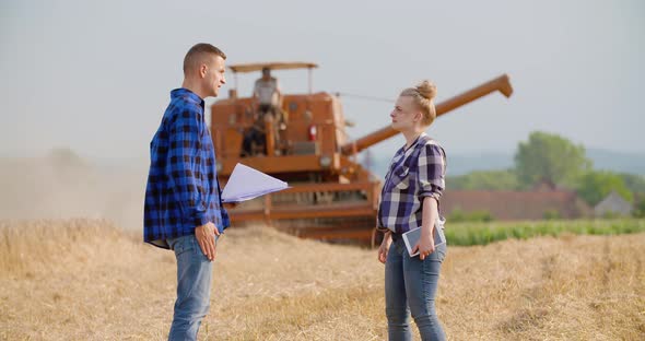 Female Farmer Discussing With Businessman On Farm alt