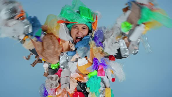 Woman wearing junk costume and showing angry emotion.