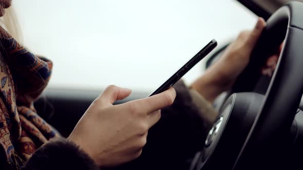 Texting And Driving Car On Smartphone.Checking Email Chats And Reading News.Female Writing Message alt