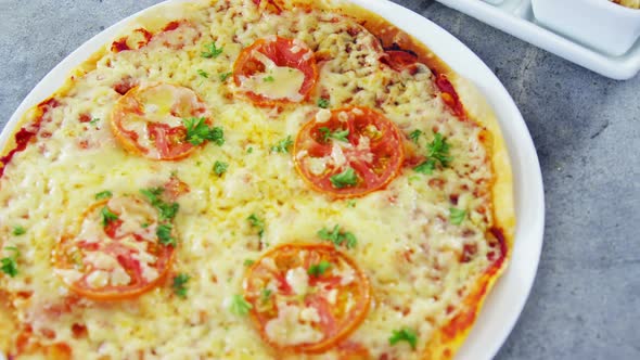 Baked pizza with cherry tomato toppings and ingredients alt