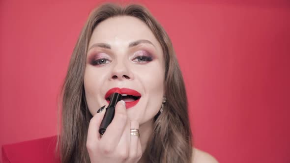 Young Girl Holding Red Lipstick and Finishing Her Makeup