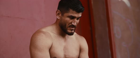 Topless Athlete sitting on a wall alt