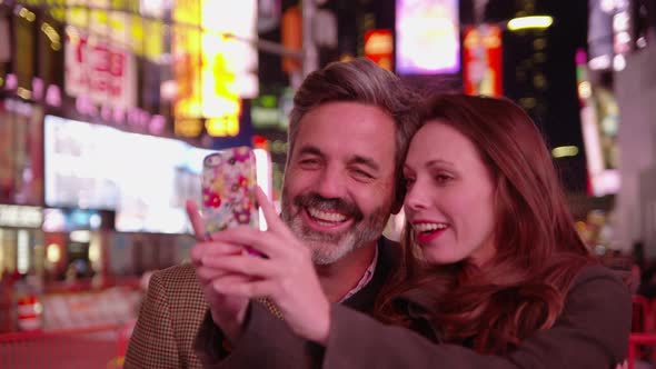 Couple taking selfie in Times Square, New York City