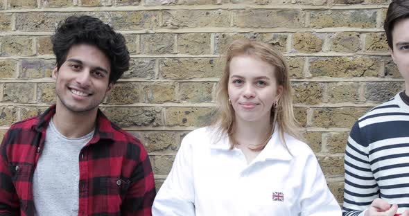Portrait of teenage boys and girls in London. Group of multiracial friends st alt