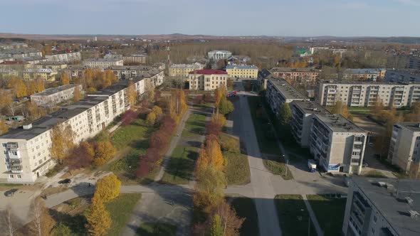 Aerial view of provincial autumn city with soviet panel houses, alley and house of culture 28 alt