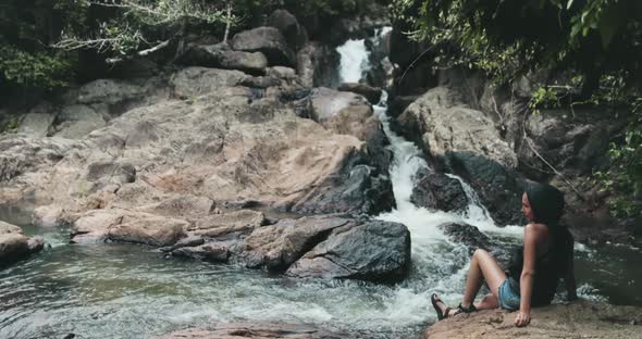 Thailand Jungle River Waterfall Tourist Sitting on Stony Bank Stream Water Fall and Enjoy of Nature