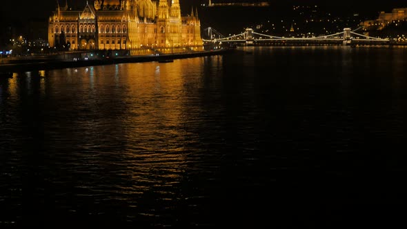 Budapest National Parliament building and river Danube by the night 4K 2160p UltraHD tilting footage alt
