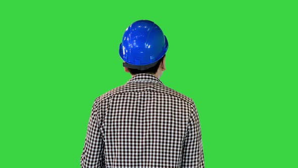 Worker in Hard Hat with Paint and Brush Walking and Looking What to Paint on a Green Screen Chroma