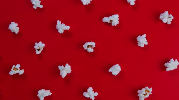 Rotation Popcorn on a Red Background Top View Closeup  the Concept of a Cinema Watching Movies