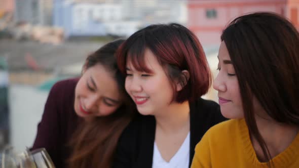 Young asian girl friends hanging out with drinks. Holiday celebration festive party. alt