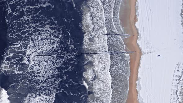 Snowy beach and waves, Baltic sea. Aerial view of winter alt