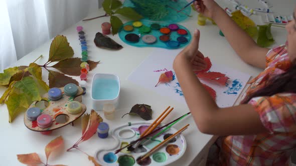 Little Girl Painting on Autumn Yellow Leaves with Gouache Kids Arts Children Creativity Autumn Art