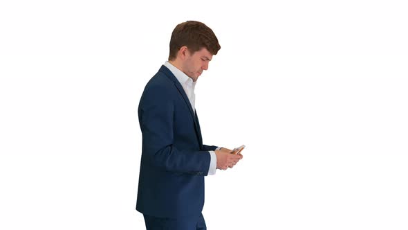 Happy Businessman Counting Money and Tucking It Inside His Jacket While Walking on White Background alt