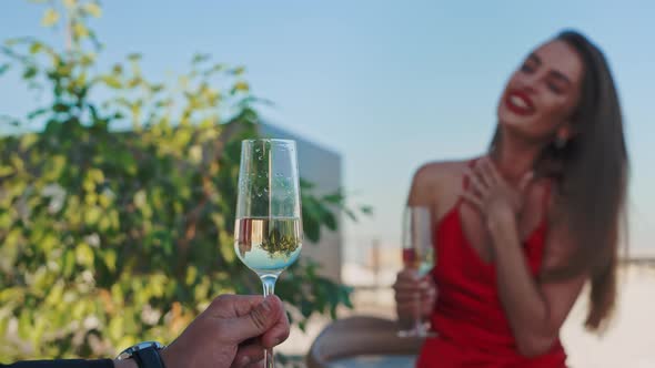Pouring Champagne Into a Glass at a Rooftop Restaurant