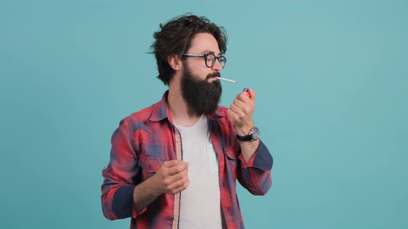 Man Tries To Light a Cigarette and Returns with a Surprised Look To the Camera alt