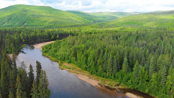 4K Drone Video of Beautiful Chena River as it runs through Pine Tree Covered Mountains near Chena Ho alt