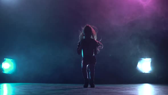 Child Girl Sit on the Twine in the Studio. Multicolor Smoke Background. Silhouette. Light From alt